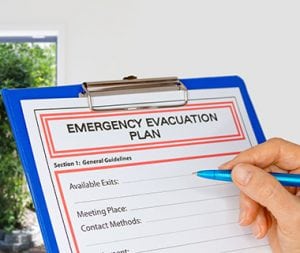 Clipboard with Emergency Evacuation Plan beside Exit Door